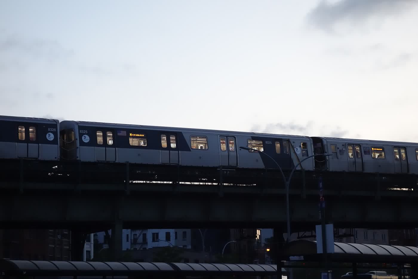 An elevated subway train crossing at first light. A small character sits on the roof, asking you to stay.
